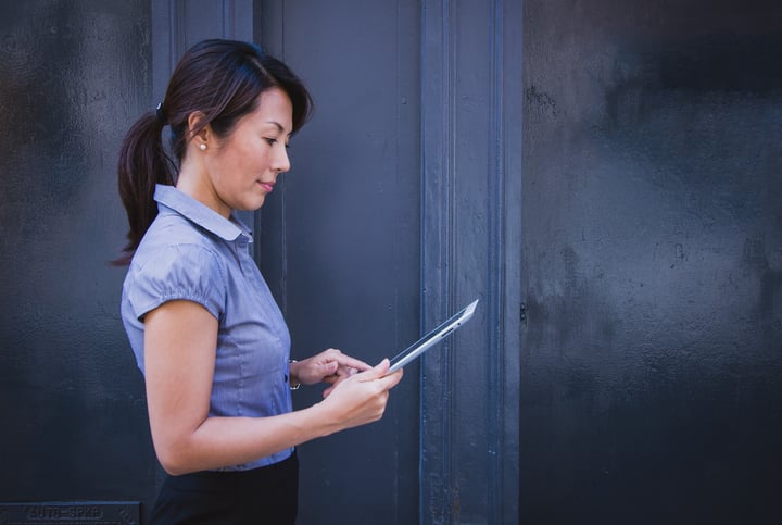 woman with iPad looking at intranet